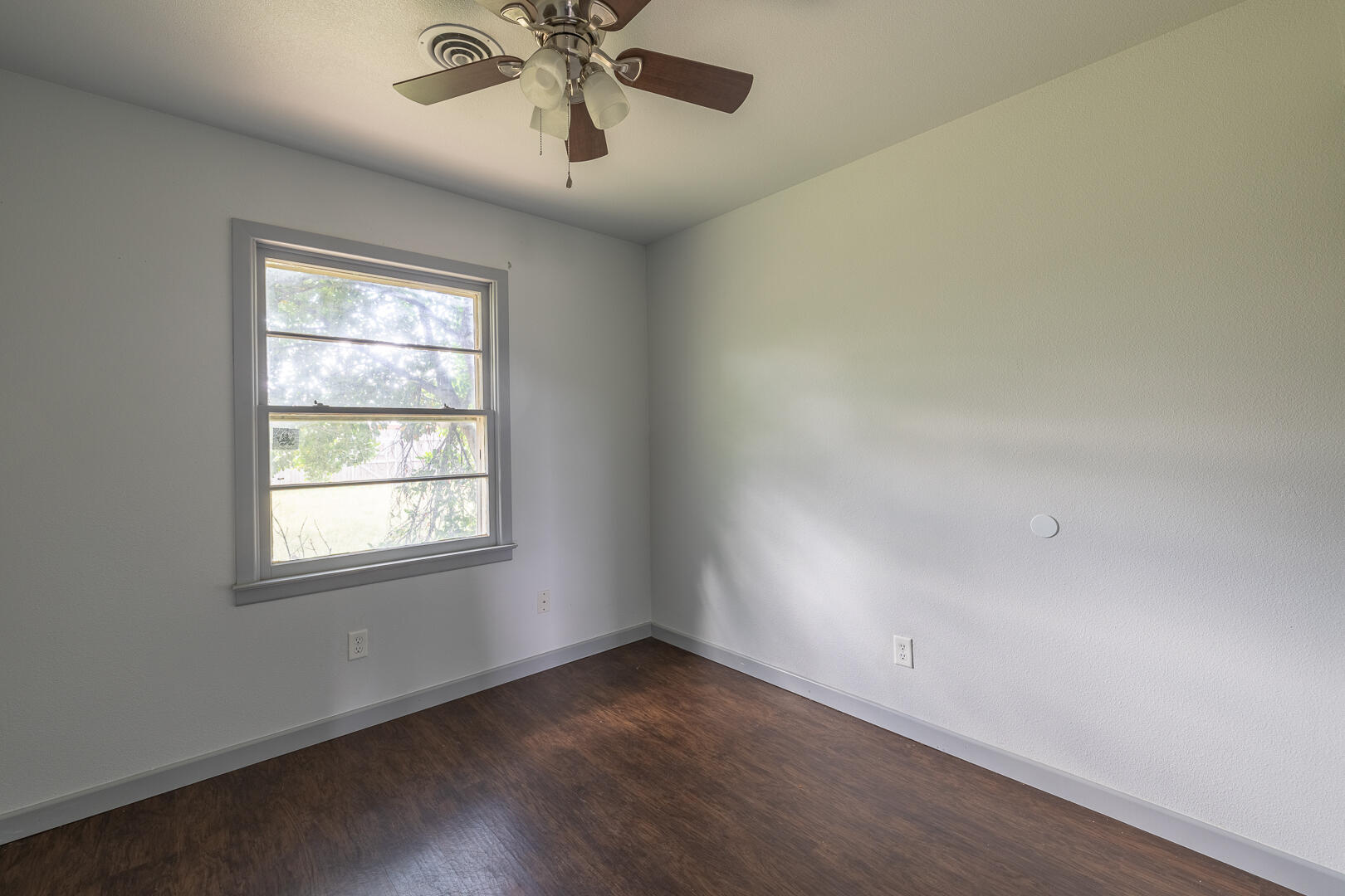 5403 13th Street Lubbock, TX 79416 - Photo 21 of 28 an empty room with a window and a fan