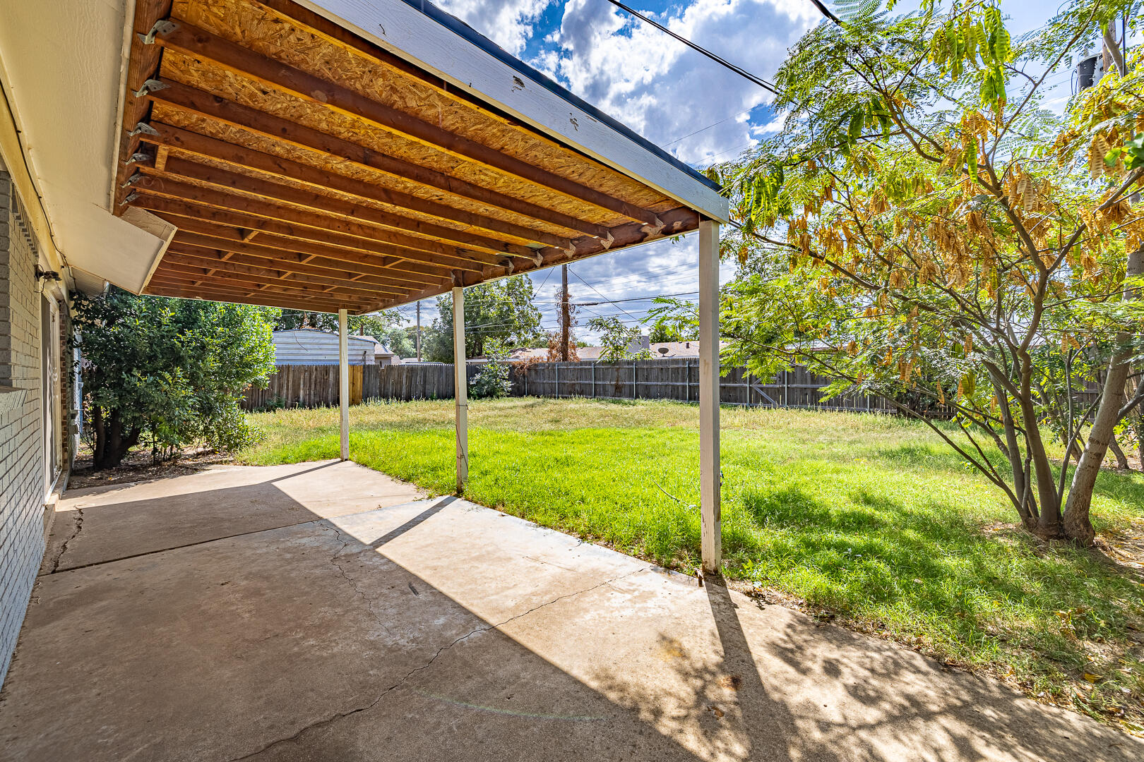 5403 13th Street Lubbock, TX 79416 - Photo 24 of 28 a view of a backyard with wooden fence