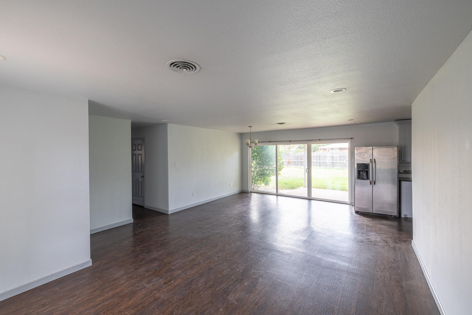 5403 13th Street Lubbock, TX 79416 - Photo 5 of 28 a view of an empty room with wooden floor and a window