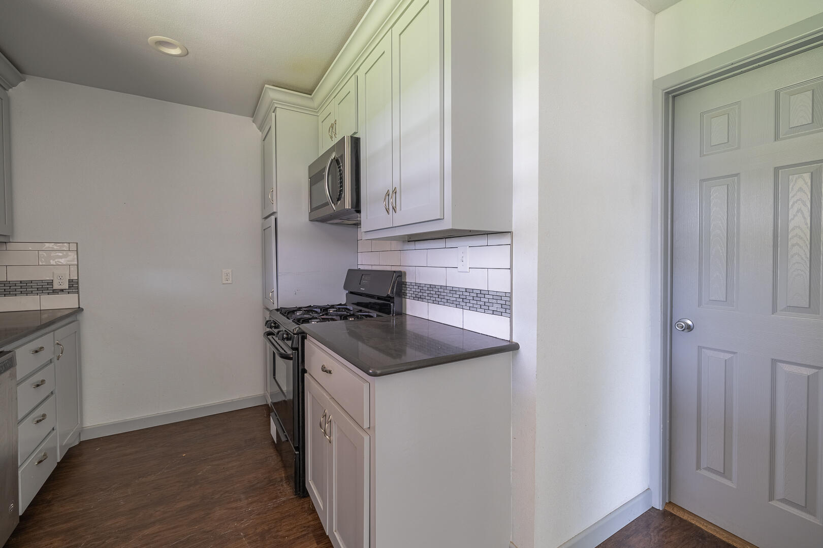 5403 13th Street Lubbock, TX 79416 - Photo 7 of 28 a kitchen with stainless steel appliances granite countertop a sink and a stove top oven