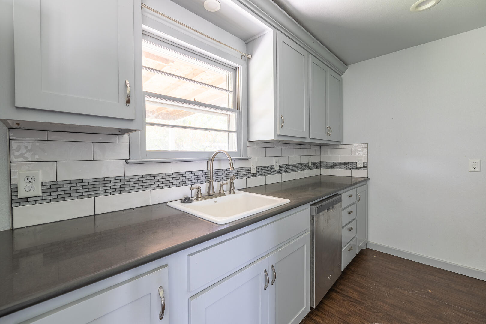 5403 13th Street Lubbock, TX 79416 - Photo 9 of 28 a kitchen with a sink cabinets and window