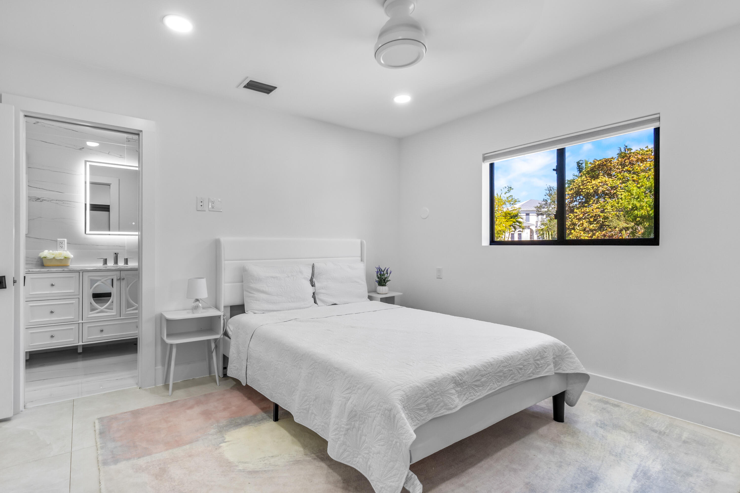 501 High Street Boca Raton, FL 33432 - Photo 11 of 27 a bedroom with a bed a painting on the wall and dresser