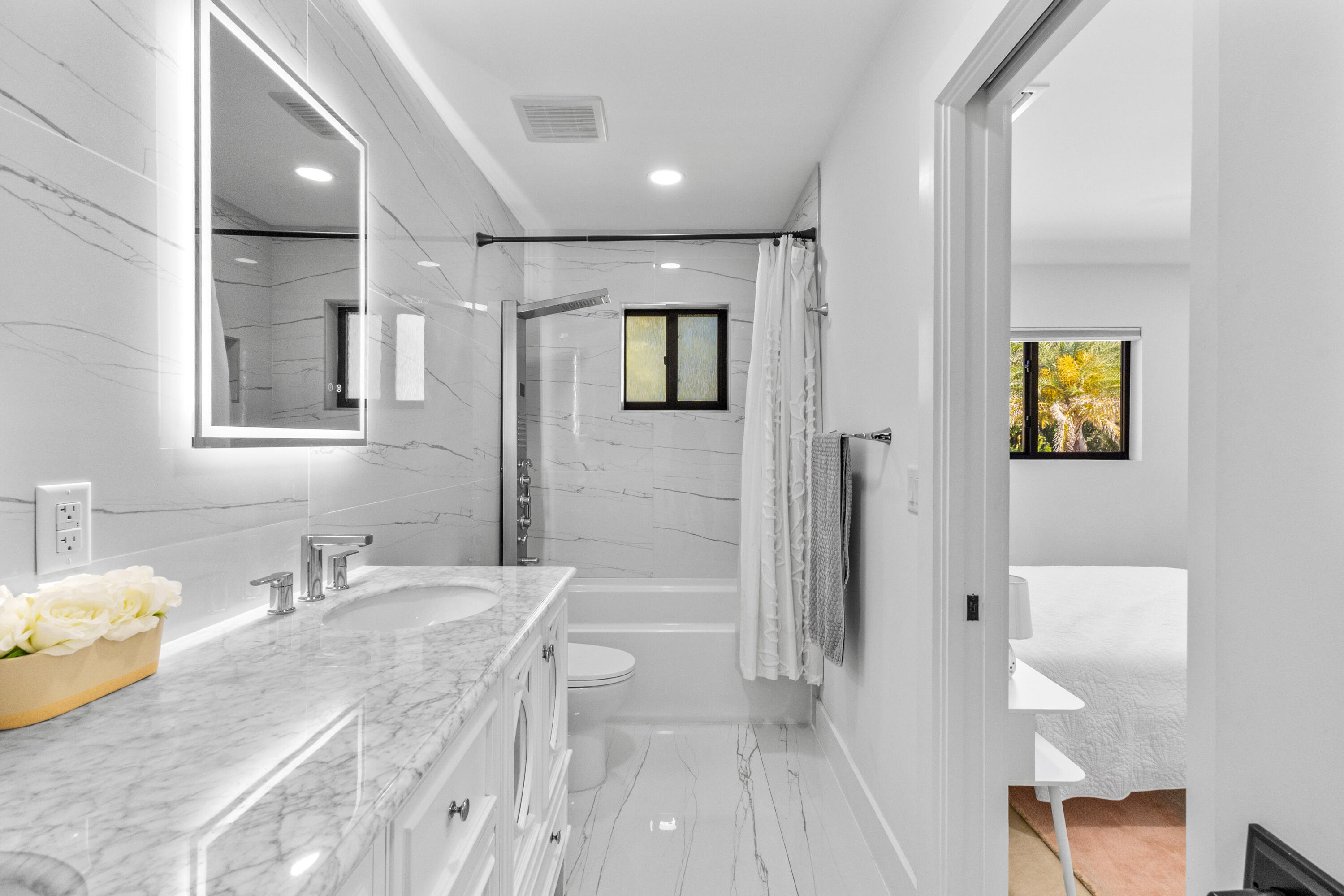 501 High Street Boca Raton, FL 33432 - Photo 13 of 27 a bathroom with a granite countertop sink a toilet a shower and a mirror