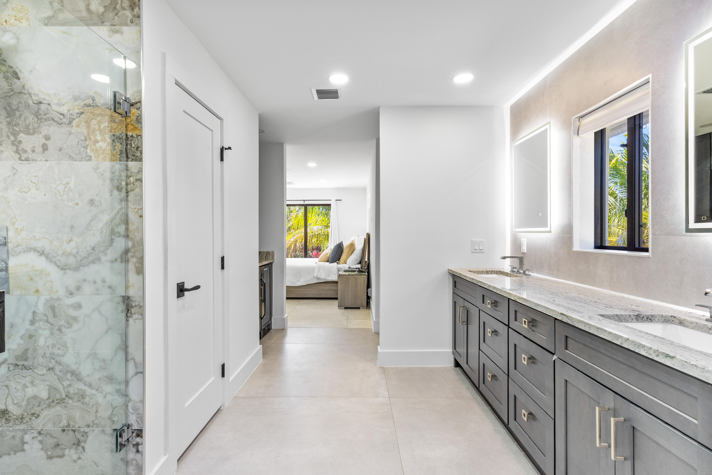 501 High Street Boca Raton, FL 33432 - Photo 10 of 27 a spacious bathroom with a granite countertop double vanity sink a mirror and a bathtub