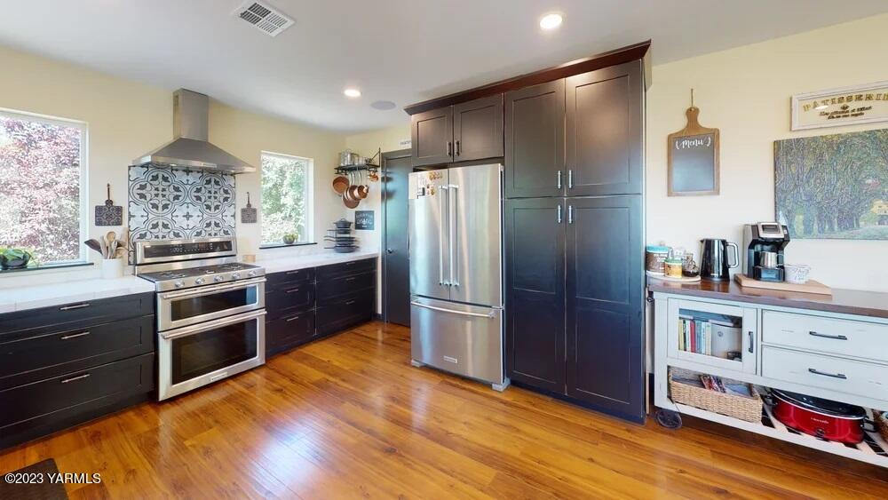 14751 Cottonwood Canyon Road Yakima, WA 98908 - Photo 11 of 53 a kitchen with stainless steel appliances and wooden cabinets