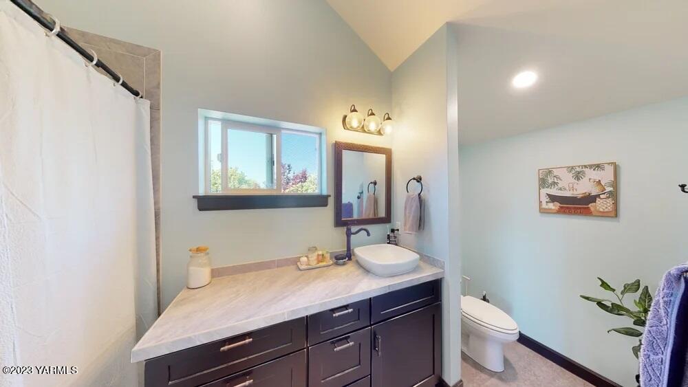 14751 Cottonwood Canyon Road Yakima, WA 98908 - Photo 25 of 53 a bathroom with a granite countertop toilet sink and mirror