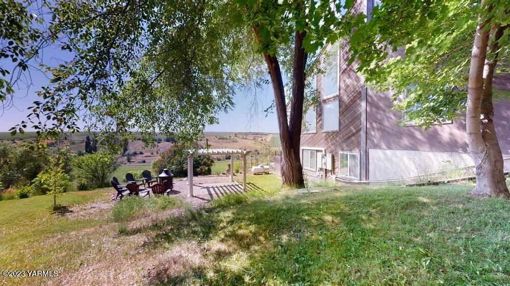 14751 Cottonwood Canyon Road Yakima, WA 98908 - Photo 38 of 53 a view of a backyard with a large tree