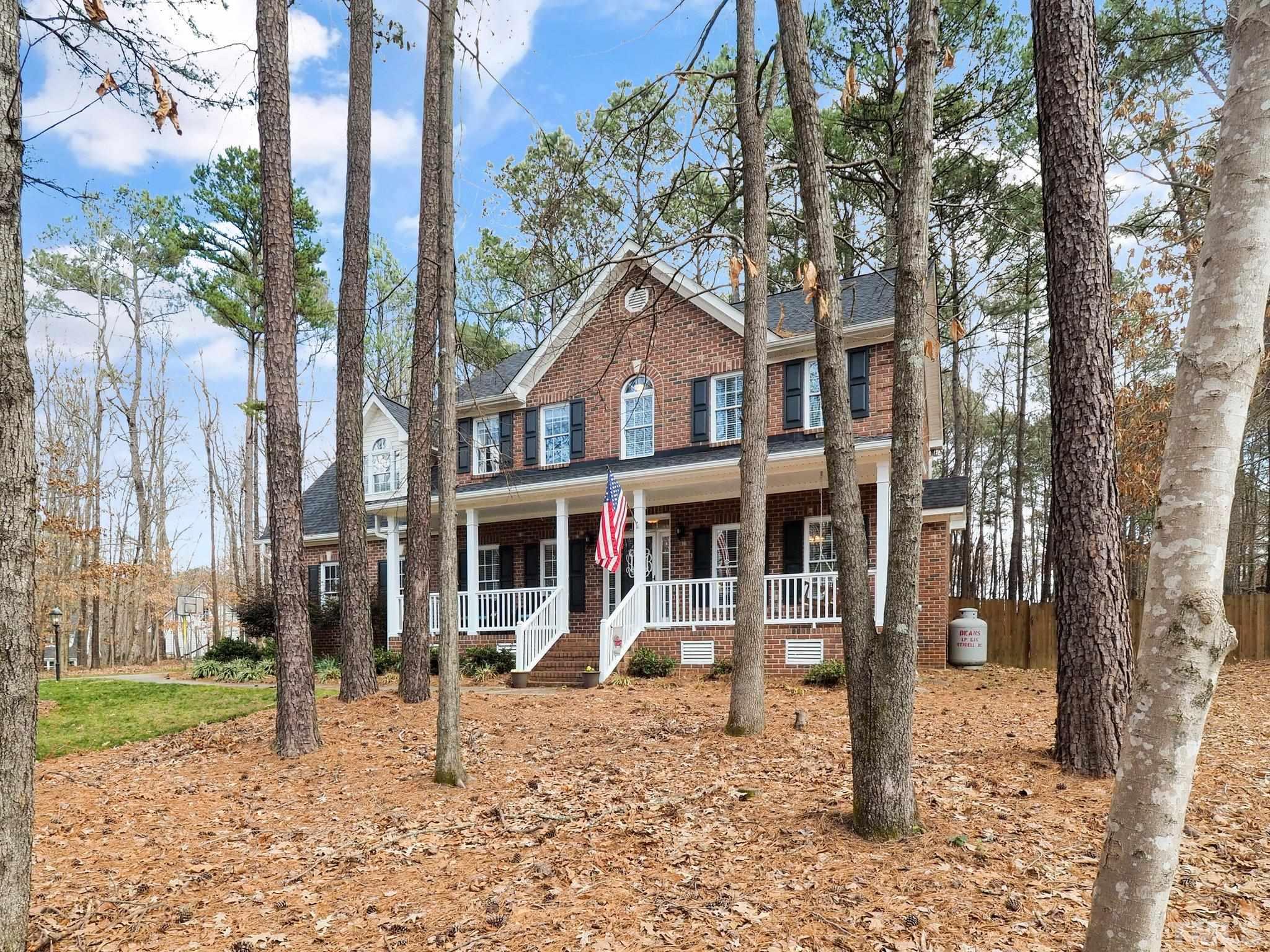 4412 Black Lion Way Raleigh, NC 27610 - Photo 1 of 32 a front view of a house with a yard tree and wooden fence