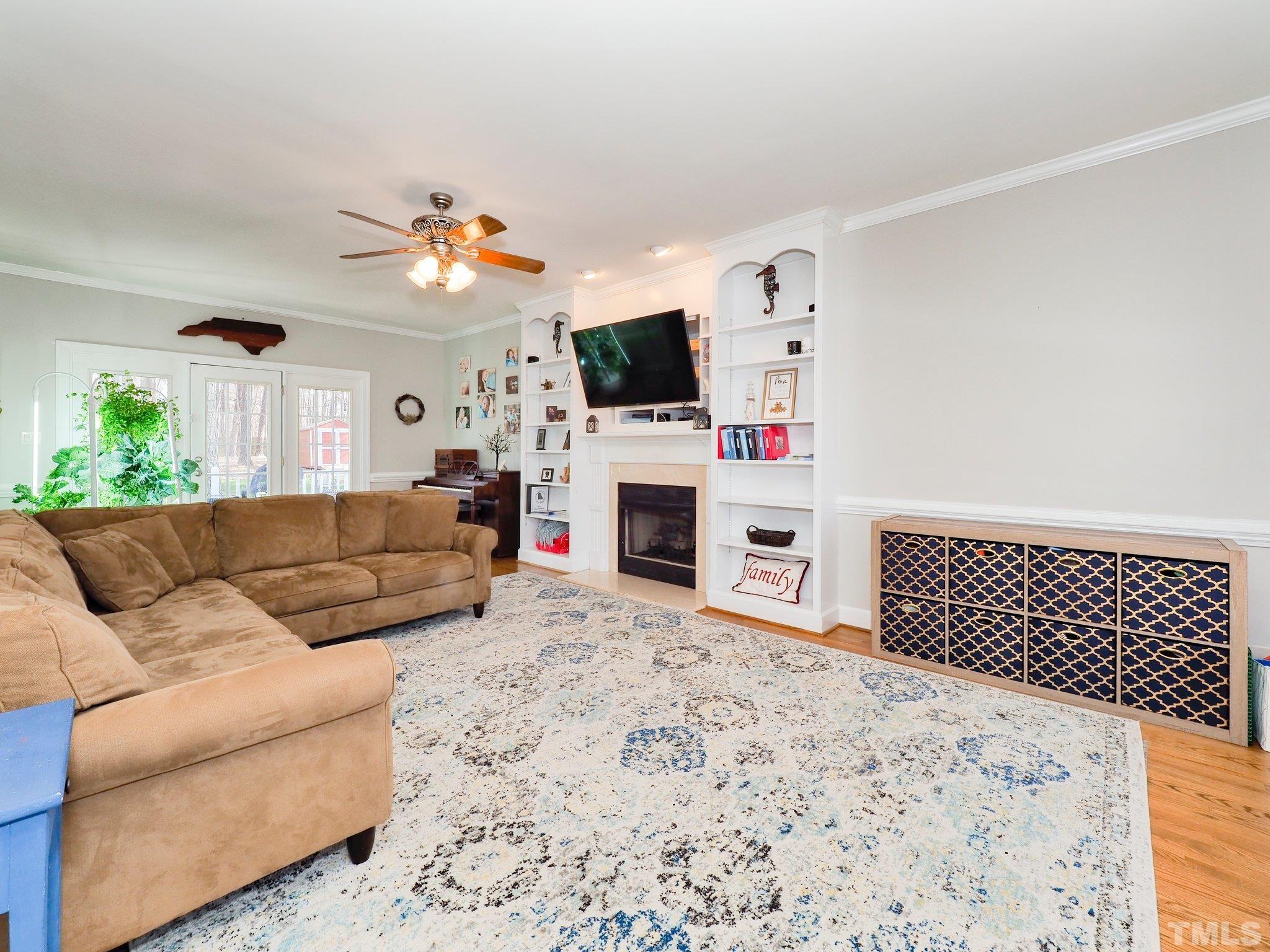 4412 Black Lion Way Raleigh, NC 27610 - Photo 11 of 32 a living room with furniture a flat screen tv and a fireplace