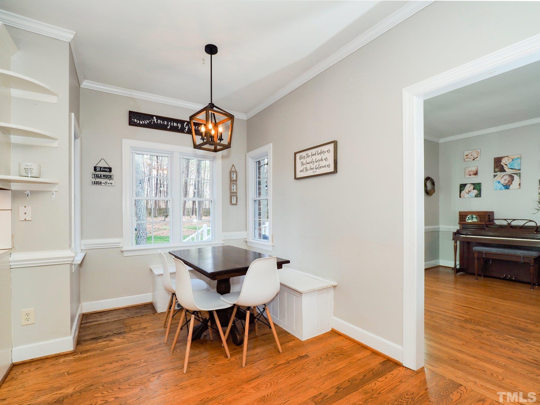 4412 Black Lion Way Raleigh, NC 27610 - Photo 12 of 32 a view of a dining room with furniture window and wooden floor