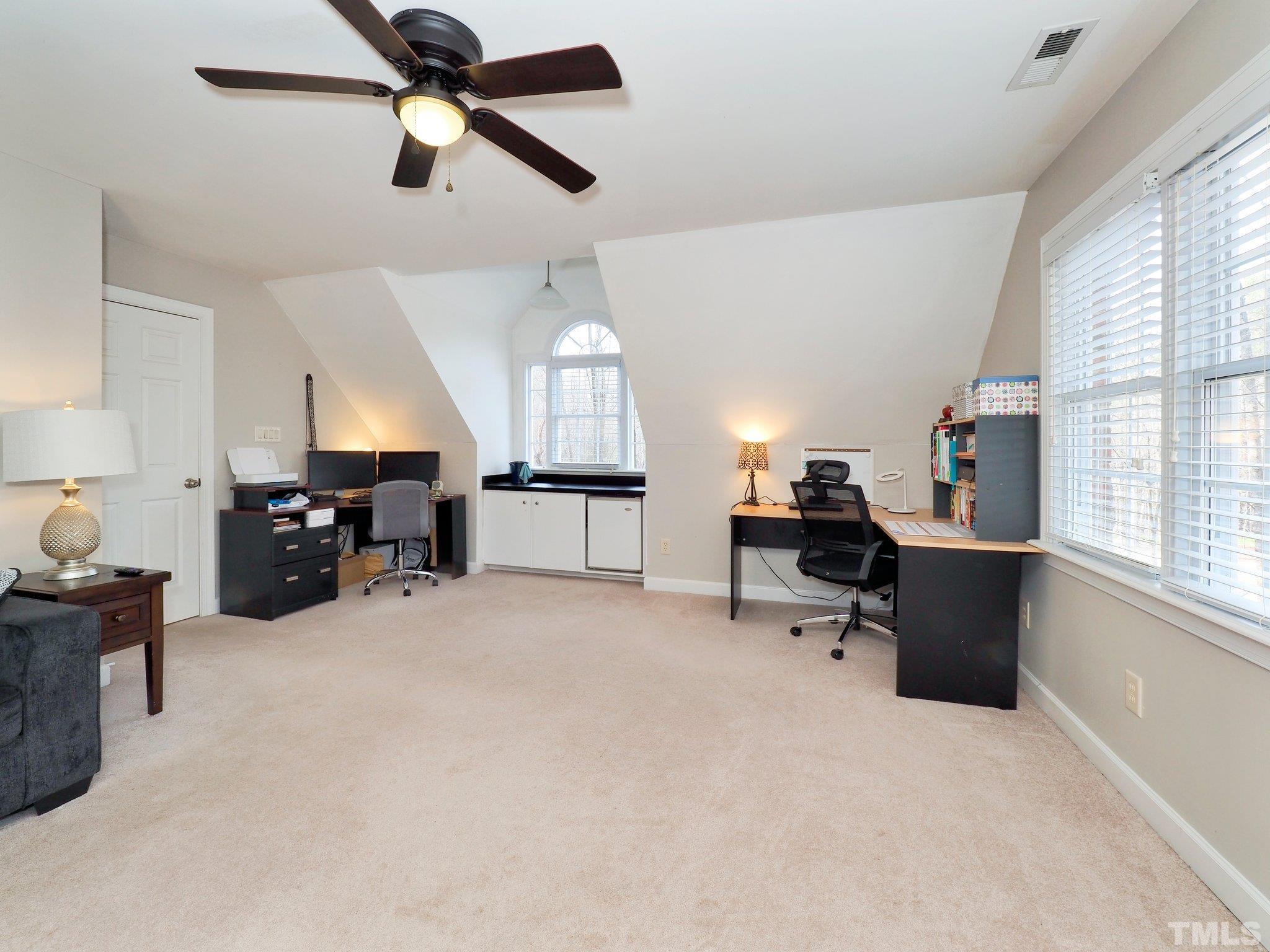 4412 Black Lion Way Raleigh, NC 27610 - Photo 18 of 32 a living room with furniture and a chandelier
