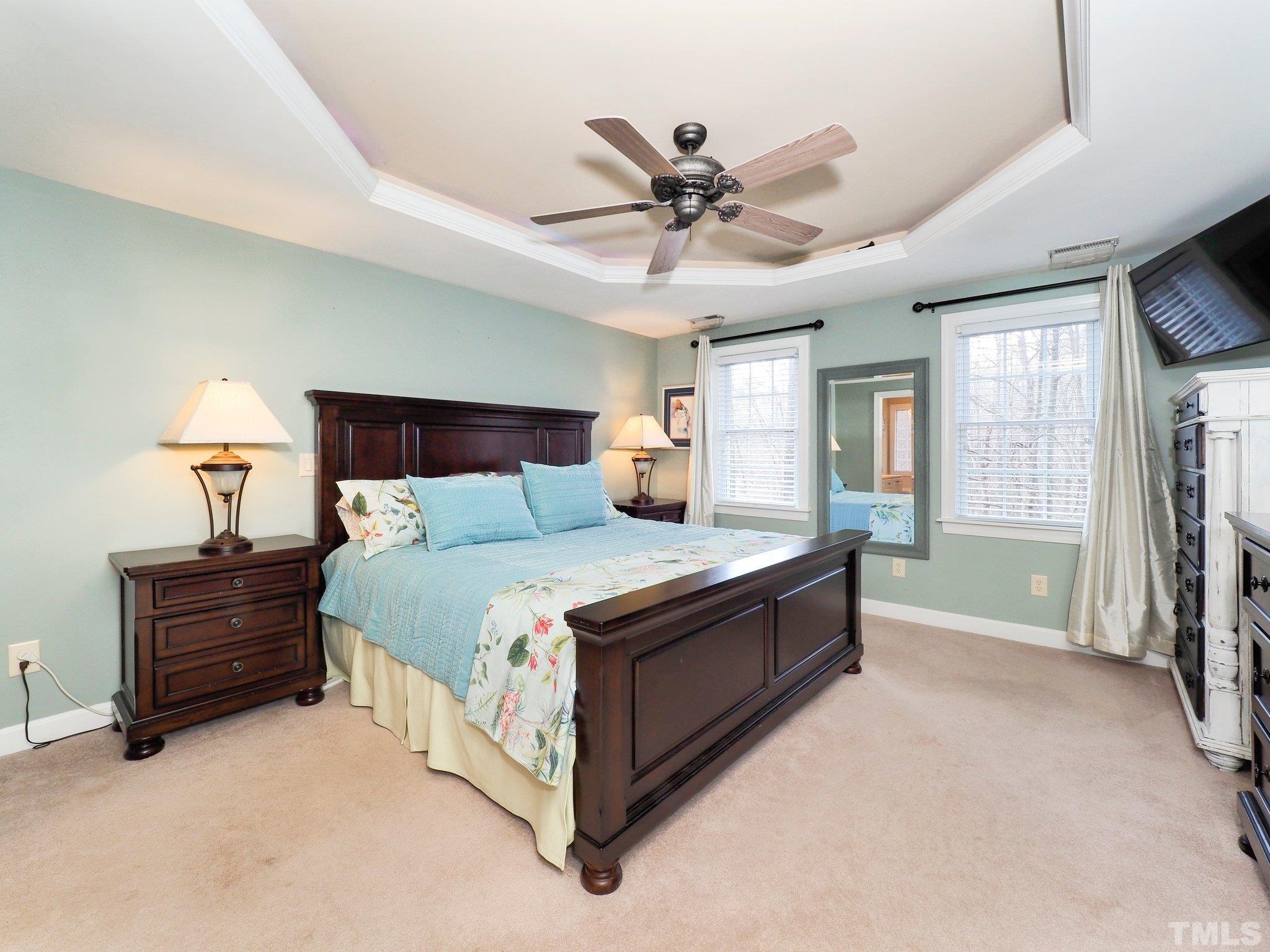 4412 Black Lion Way Raleigh, NC 27610 - Photo 19 of 32 a bed room with a bed and a chandelier