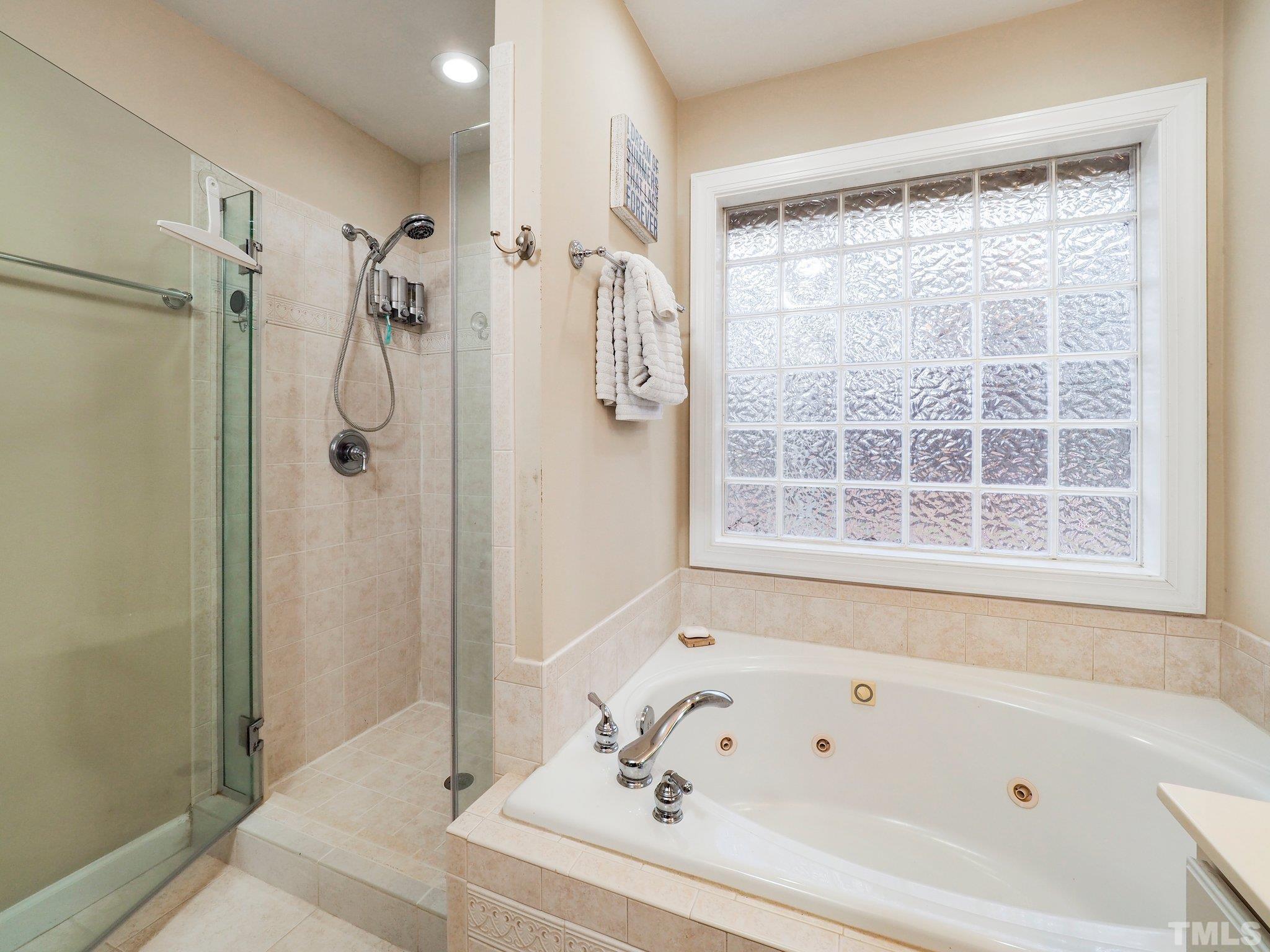 4412 Black Lion Way Raleigh, NC 27610 - Photo 20 of 32 a bathroom with a bathtub and a shower