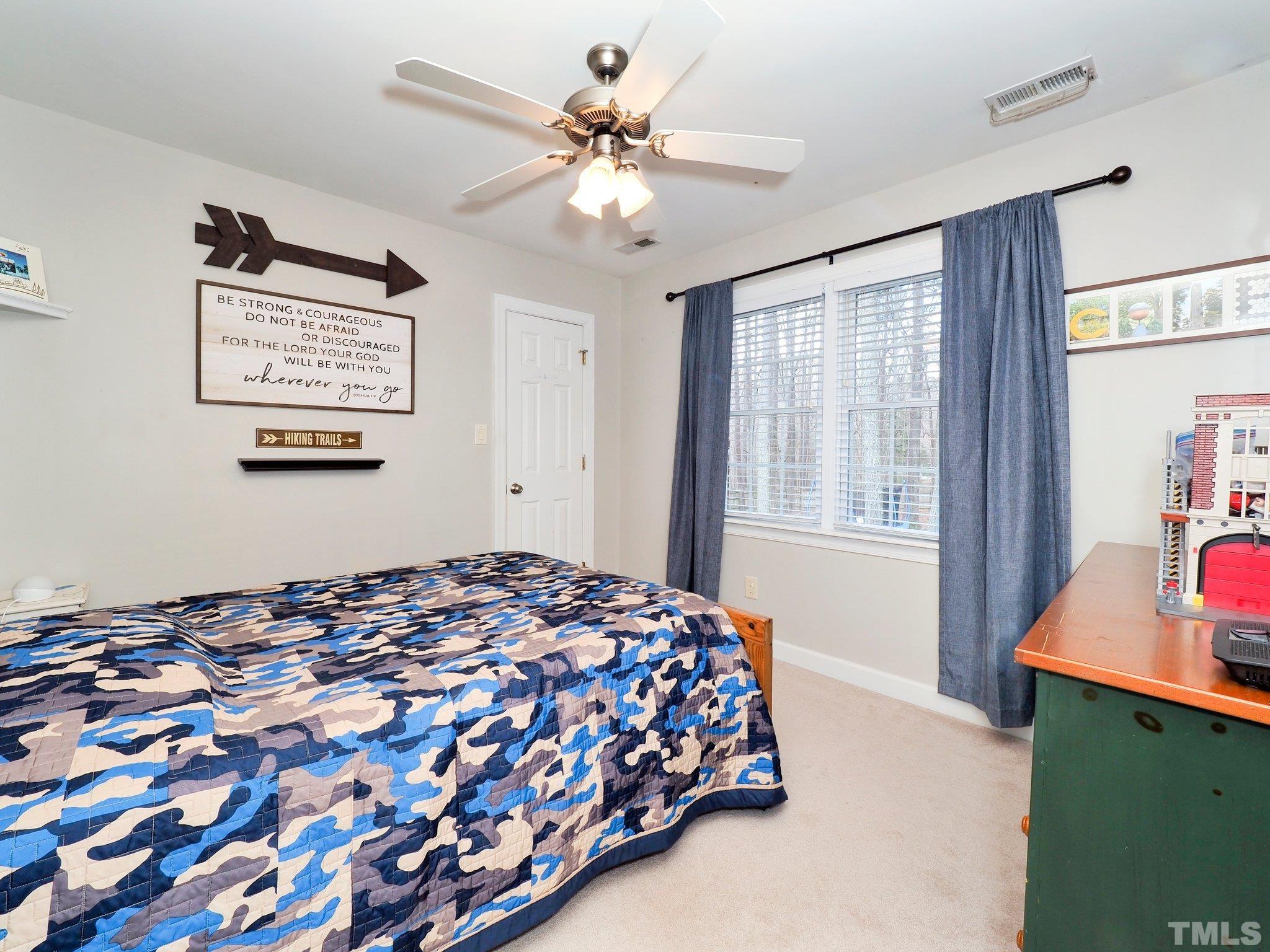 4412 Black Lion Way Raleigh, NC 27610 - Photo 22 of 32 a bedroom with a bed and a window