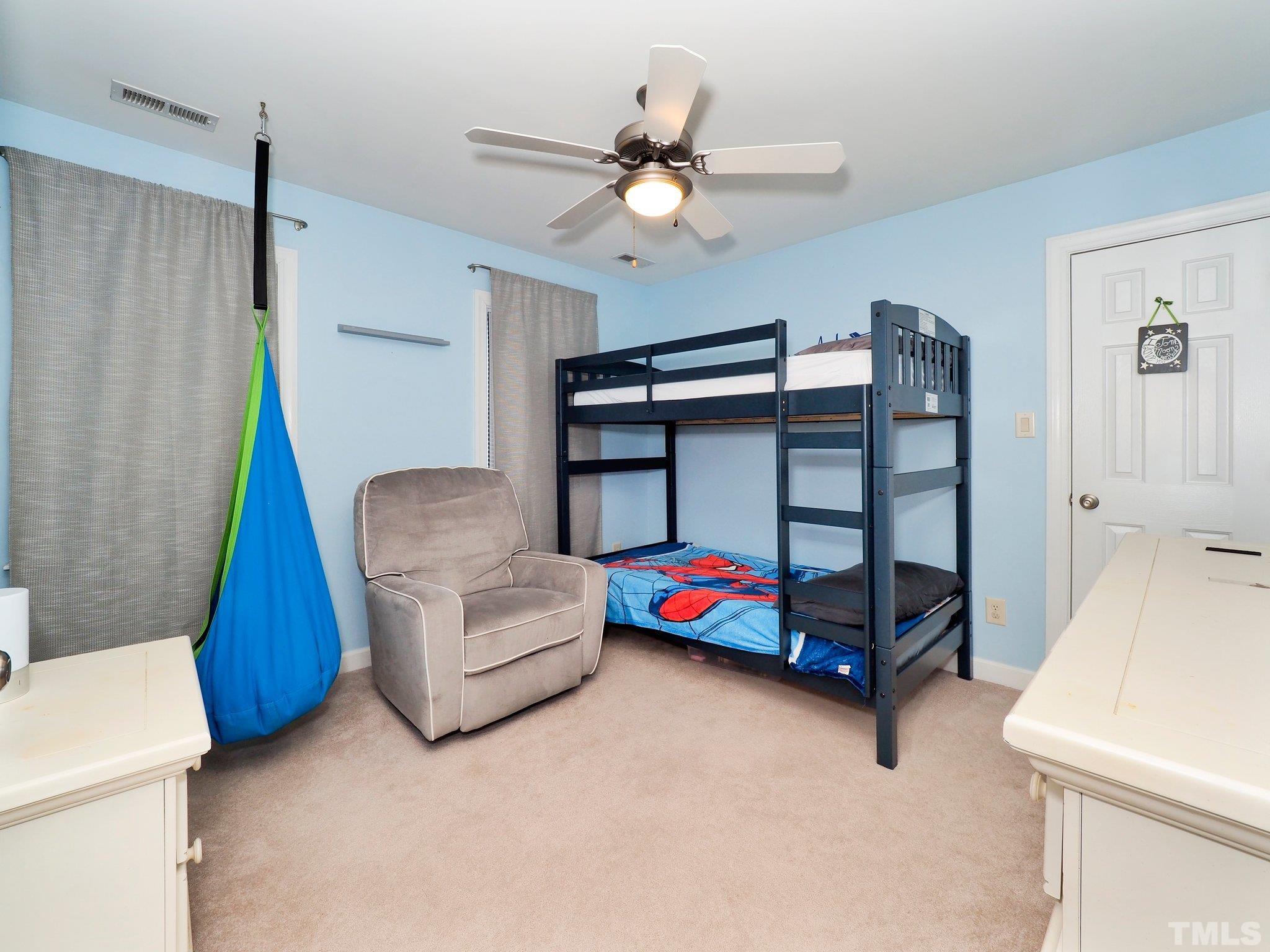 4412 Black Lion Way Raleigh, NC 27610 - Photo 23 of 32 a living room with furniture and a baby crib