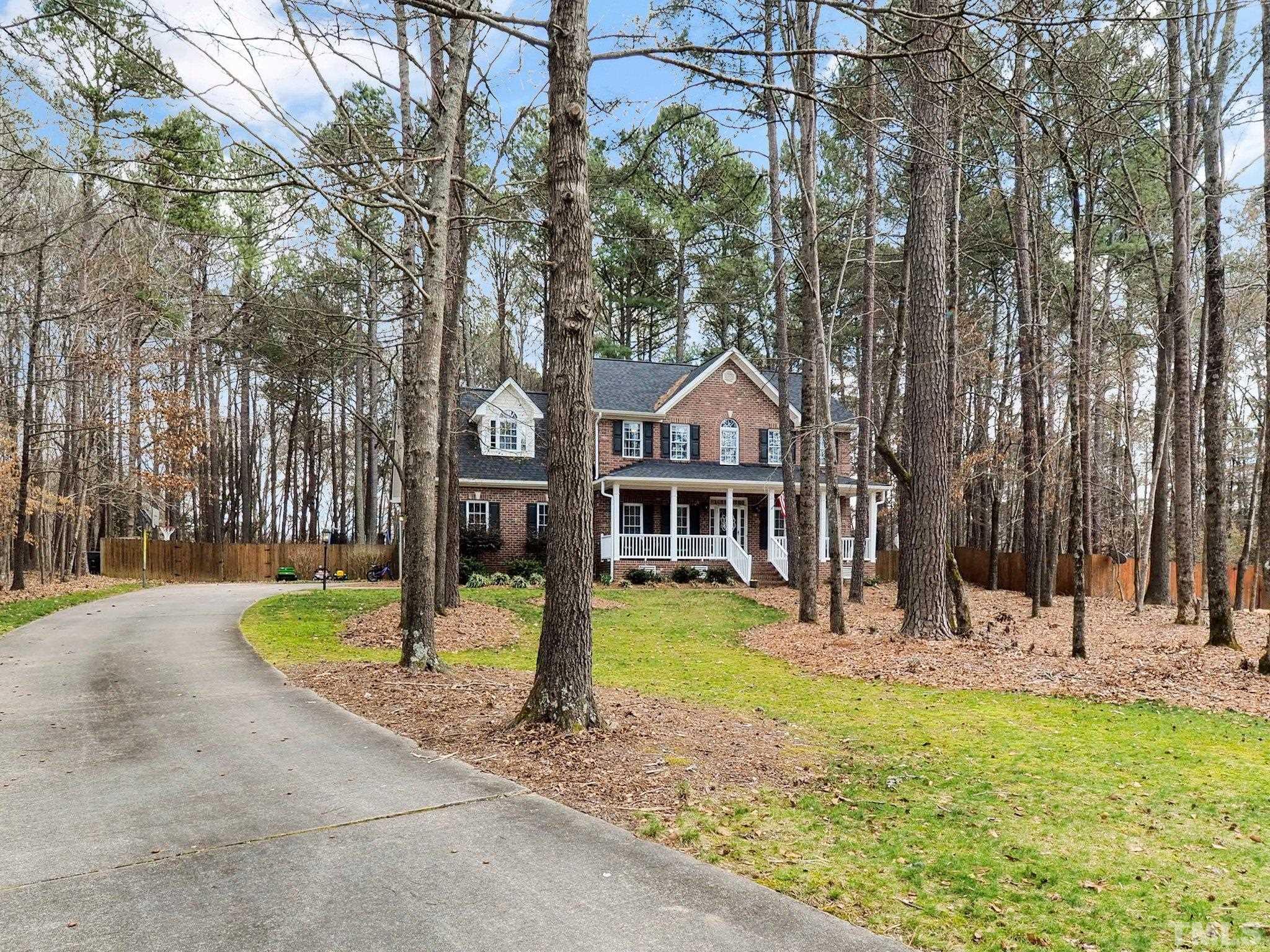 4412 Black Lion Way Raleigh, NC 27610 - Photo 3 of 32 a front view of a house with a yard table and chairs