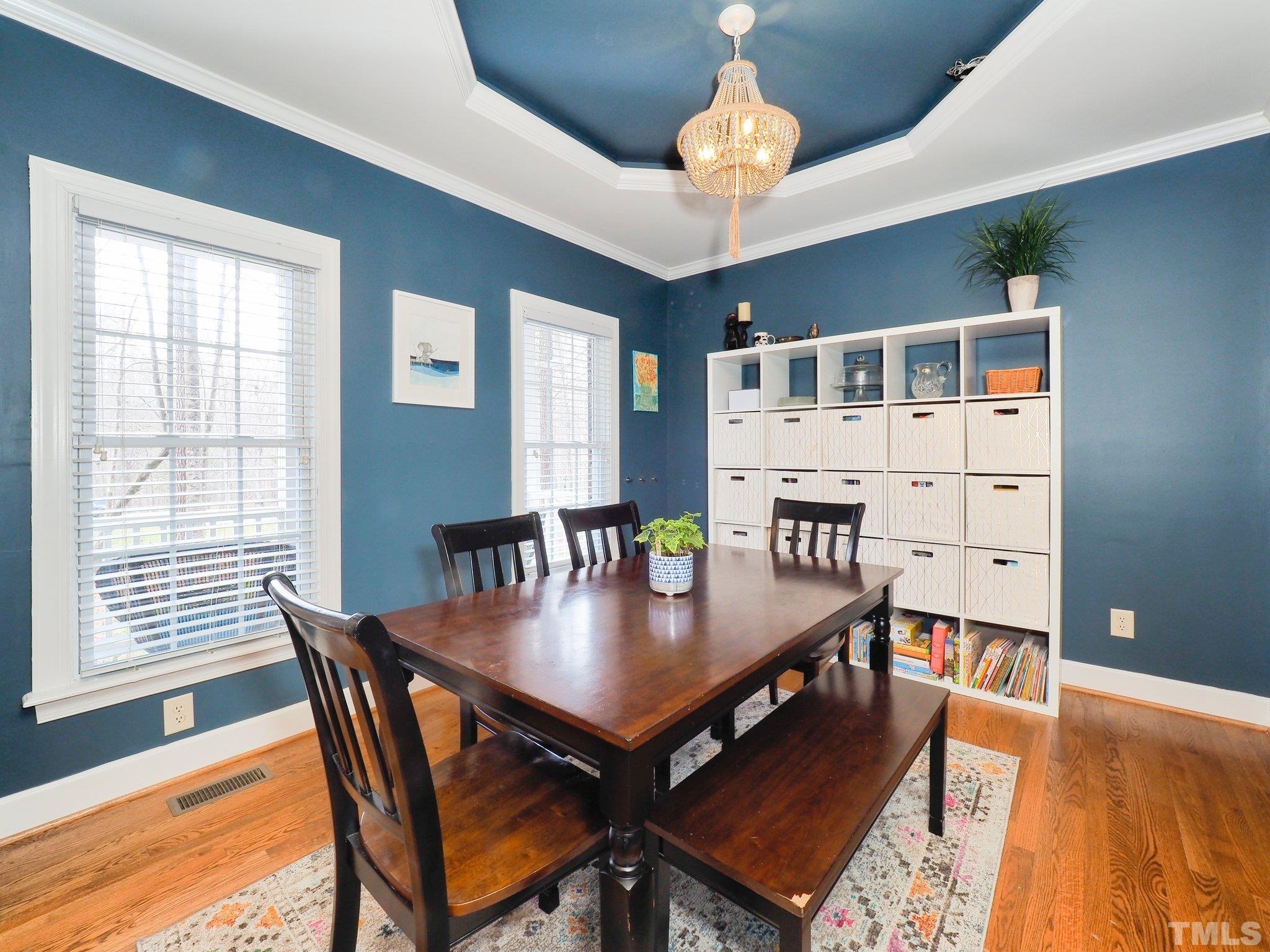 4412 Black Lion Way Raleigh, NC 27610 - Photo 9 of 32 a view of a dining room with furniture window and wooden floor