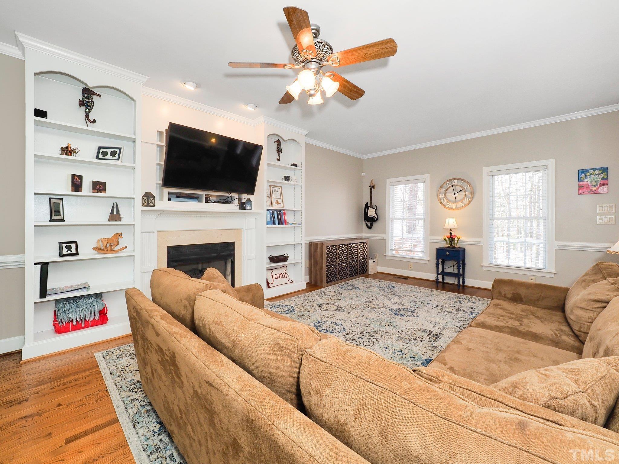 4412 Black Lion Way Raleigh, NC 27610 - Photo 10 of 32 a living room with fireplace furniture and a flat screen tv