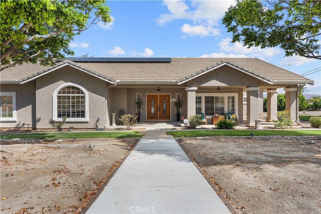a front view of a house with garden