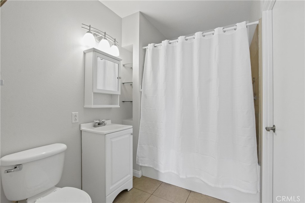 388 East Ocean Boulevard, Unit 302 Long Beach, CA 90802 - Photo 11 of 20 a bathroom with a toilet a sink and curtain