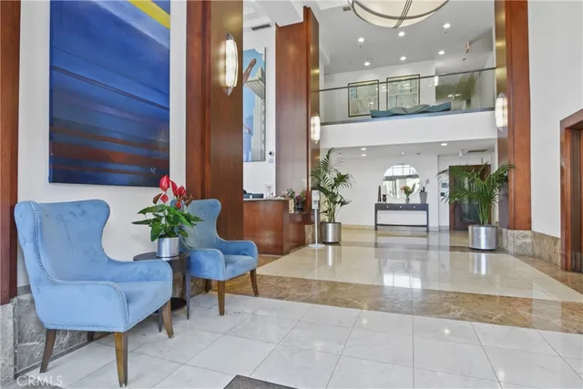 a lobby with furniture and a potted plant