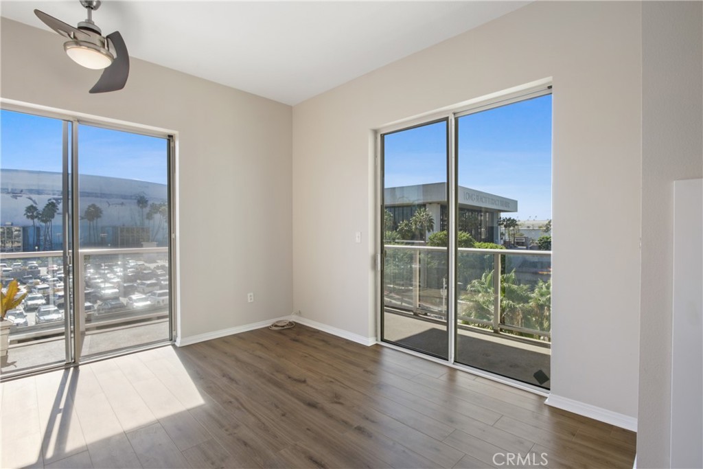 388 East Ocean Boulevard, Unit 302 Long Beach, CA 90802 - Photo 6 of 20 a view of an empty room with wooden floor and a window