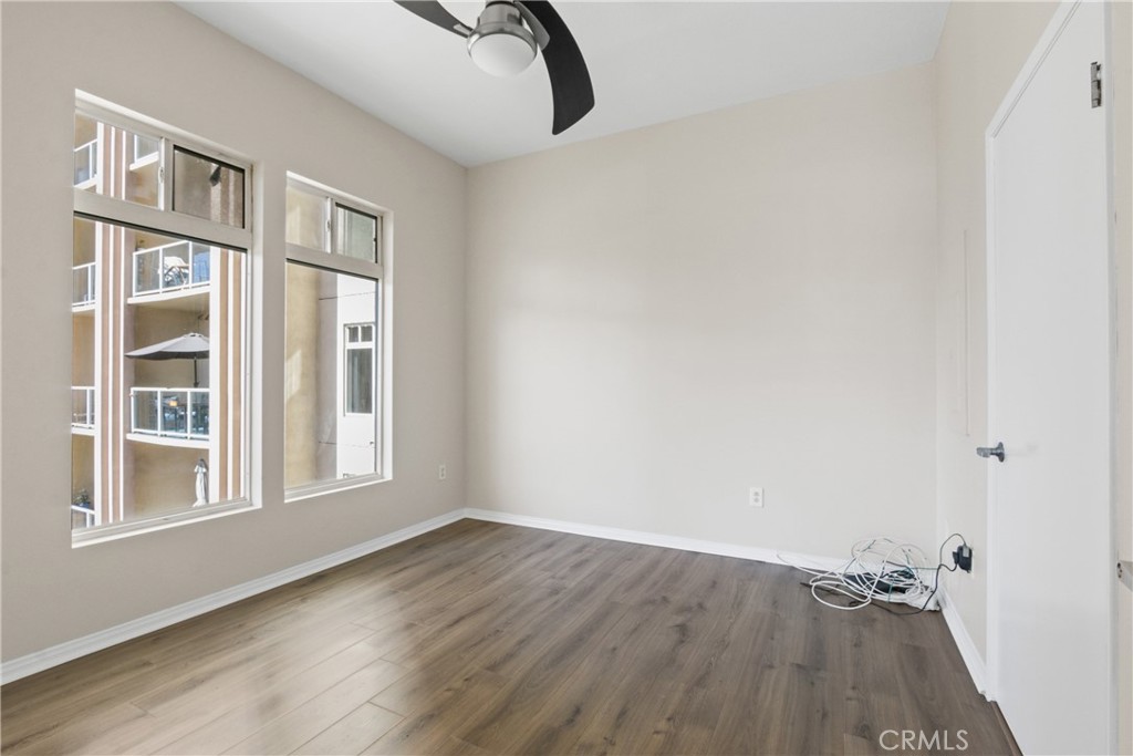 388 East Ocean Boulevard, Unit 302 Long Beach, CA 90802 - Photo 9 of 20 an empty room with wooden floor and windows