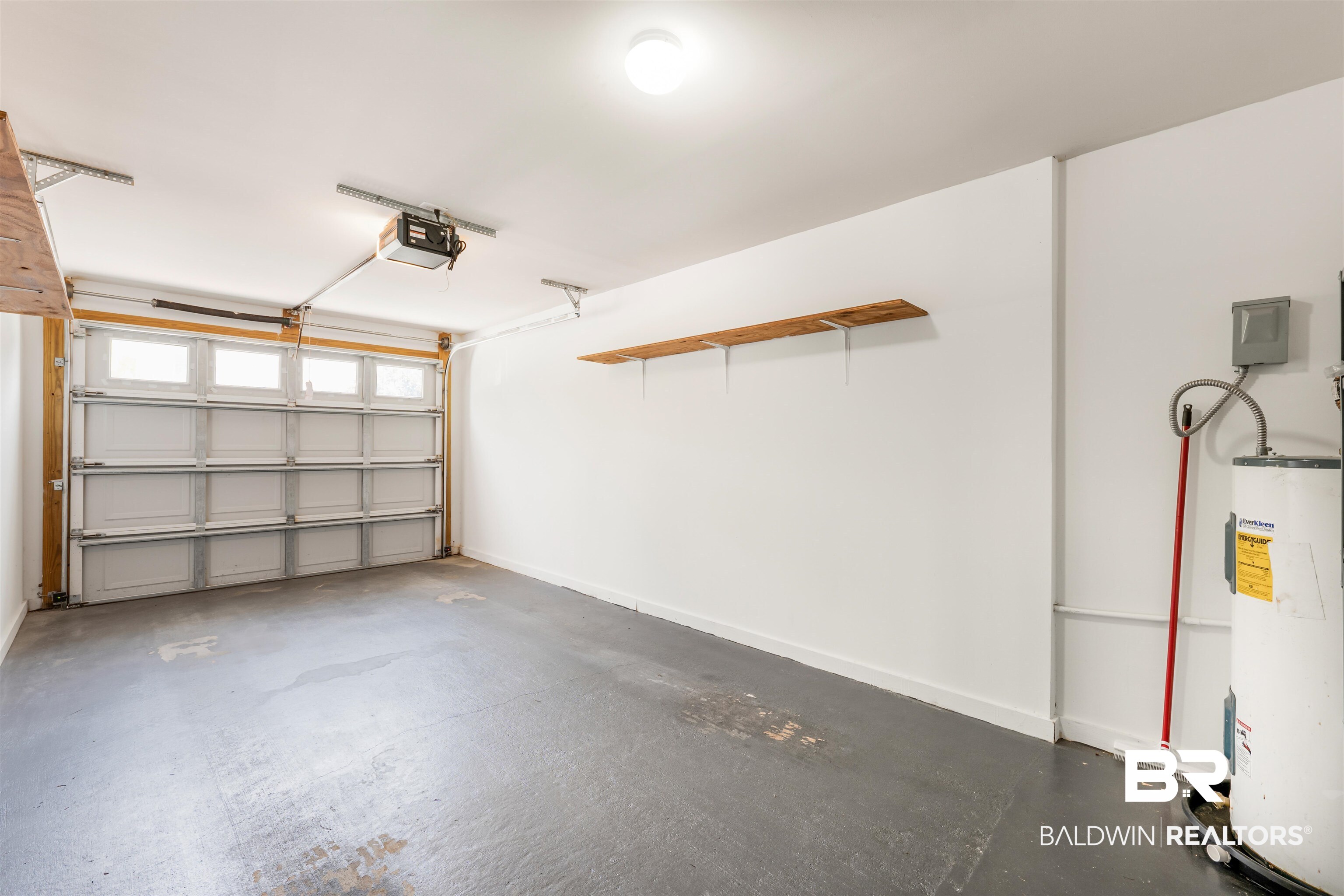 1517 Regency Road, Unit 85 Gulf Shores, AL 36542 - Photo 20 of 32 Garage with a garage door opener and electric water heater