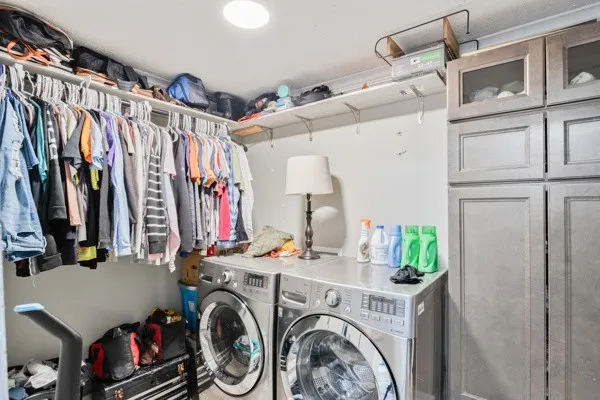 a view of walk in closet with clothes and shoes
