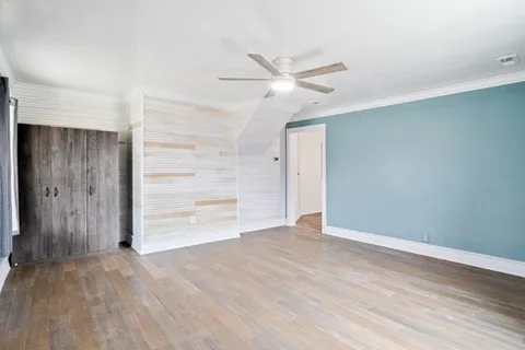an empty room with closet and windows