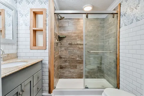 a bathroom with a shower and a sink