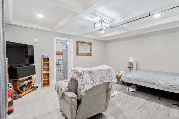 a bedroom with furniture and a flat screen tv