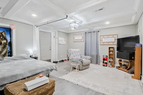 a bedroom with furniture and a flat screen tv