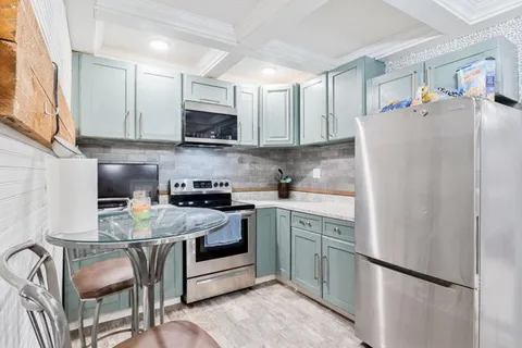 a kitchen with stainless steel appliances granite countertop a refrigerator sink and cabinets