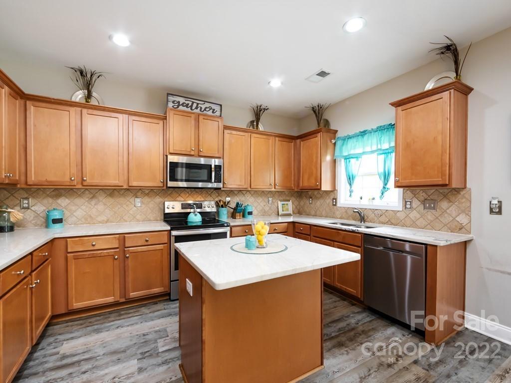2721 Gosling Terrace Road Charlotte, NC 28262 - Photo 14 of 29 a kitchen with stainless steel appliances granite countertop a sink stove and cabinets