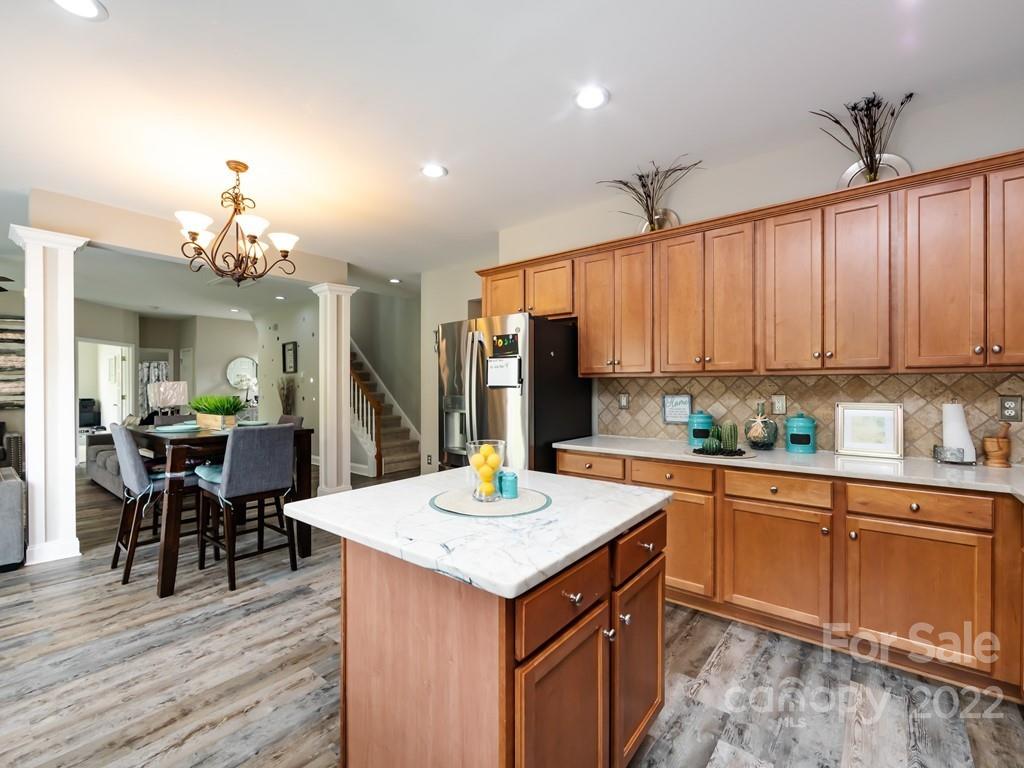2721 Gosling Terrace Road Charlotte, NC 28262 - Photo 15 of 29 a kitchen that has a lot of cabinets in it and wooden floors