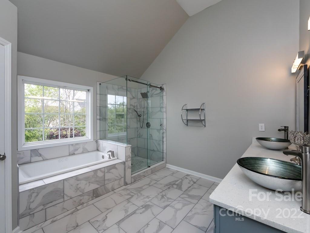 2721 Gosling Terrace Road Charlotte, NC 28262 - Photo 17 of 29 a bathroom with a granite countertop sink and a bathtub