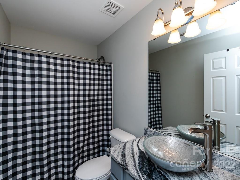 2721 Gosling Terrace Road Charlotte, NC 28262 - Photo 21 of 29 a bathroom with a sink mirror vanity and toilet