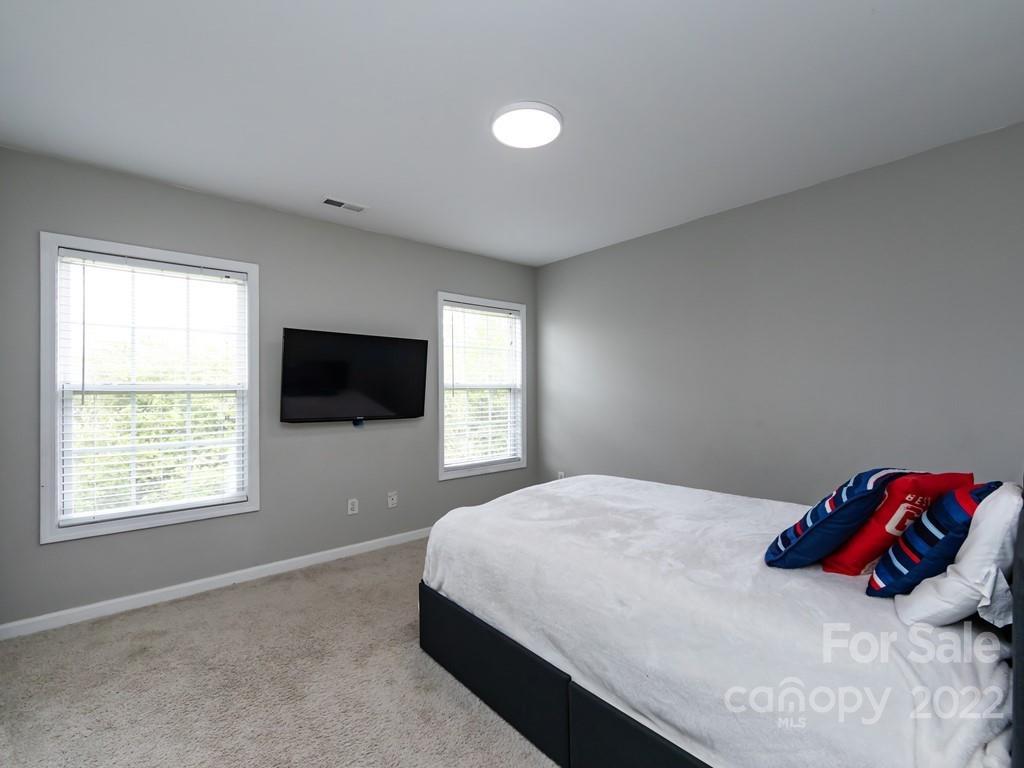 2721 Gosling Terrace Road Charlotte, NC 28262 - Photo 23 of 29 a bedroom with a bed and a flat screen tv