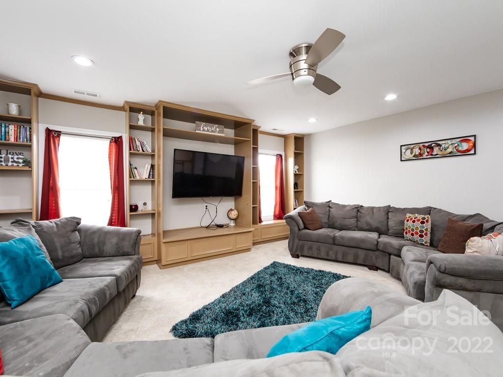2721 Gosling Terrace Road Charlotte, NC 28262 - Photo 24 of 29 a living room with furniture and a flat screen tv