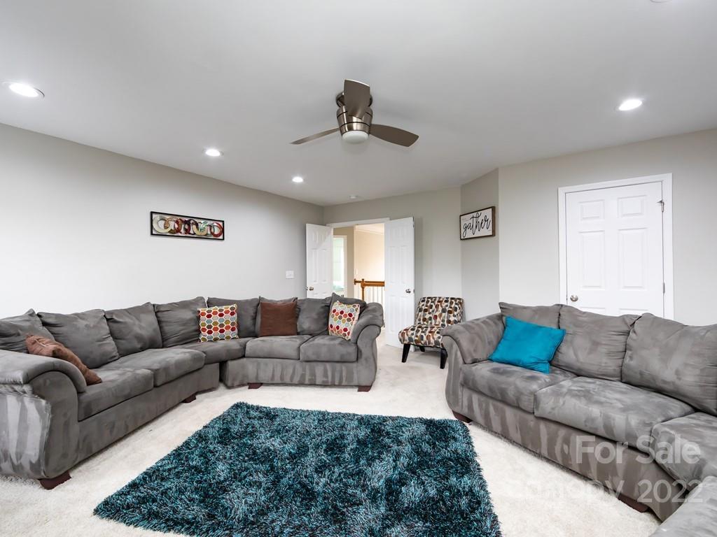 2721 Gosling Terrace Road Charlotte, NC 28262 - Photo 26 of 29 a living room with furniture and a chandelier