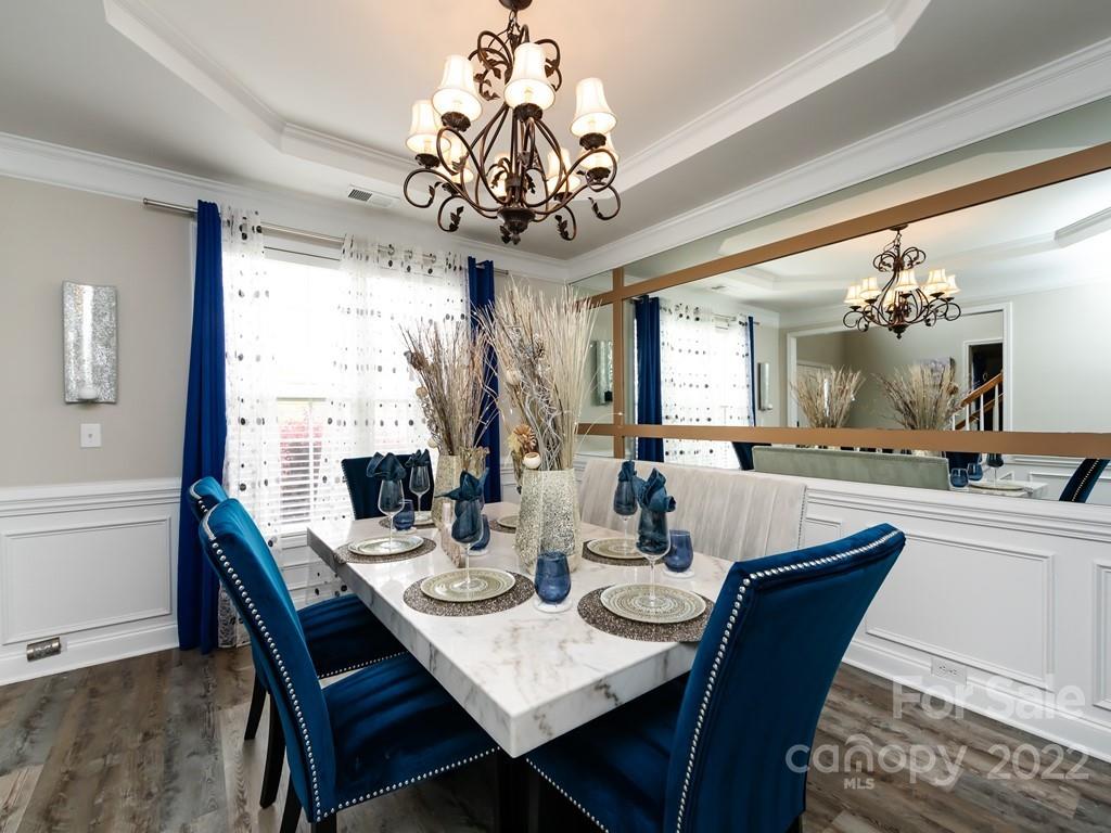 2721 Gosling Terrace Road Charlotte, NC 28262 - Photo 4 of 29 a view of a dining room with furniture a chandelier and wooden floor