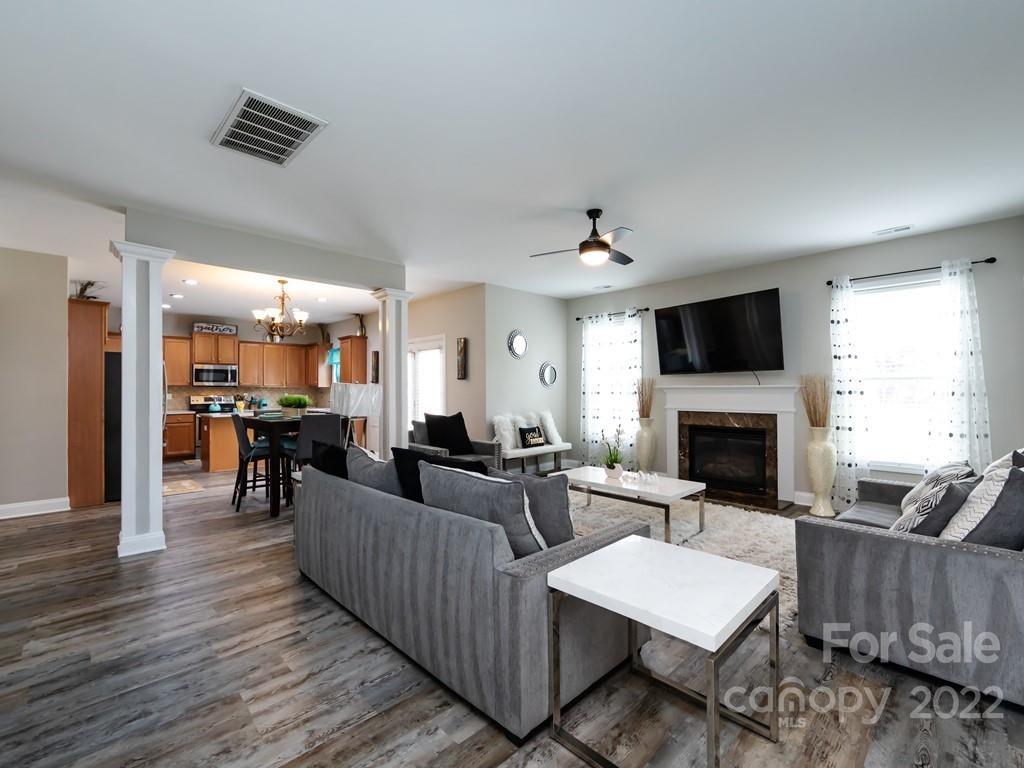 2721 Gosling Terrace Road Charlotte, NC 28262 - Photo 6 of 29 a living room with fireplace furniture and a flat screen tv
