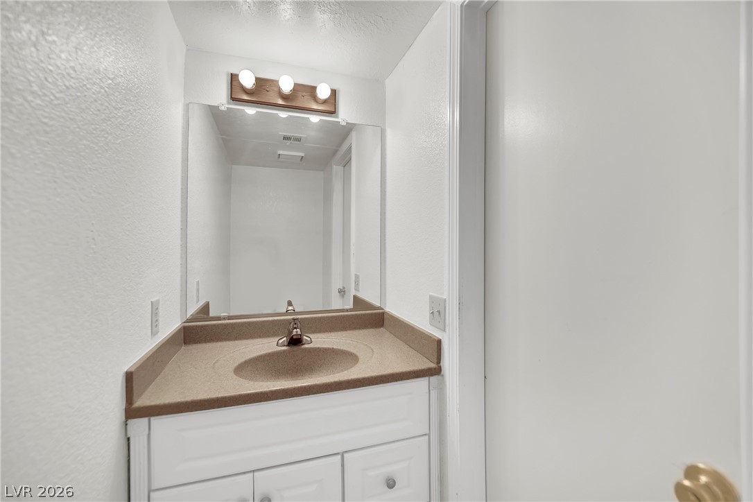 8057 Cimarron Ridge Drive Las Vegas, NV 89128 - Photo 17 of 28 Half Bath Downstairs