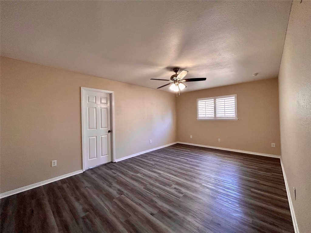 906 Spring Tree Street Round Rock, TX 78681 - Photo 11 of 18 a view of an empty room with wooden floor and a window