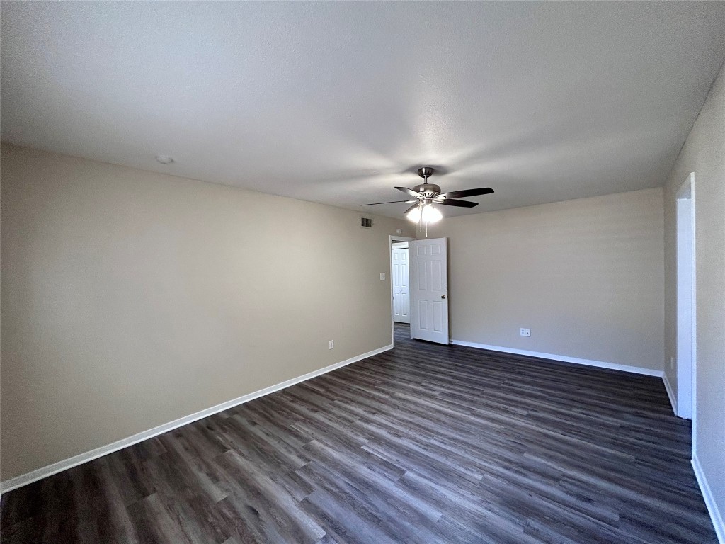 906 Spring Tree Street Round Rock, TX 78681 - Photo 13 of 18 a view of an empty room with wooden floor