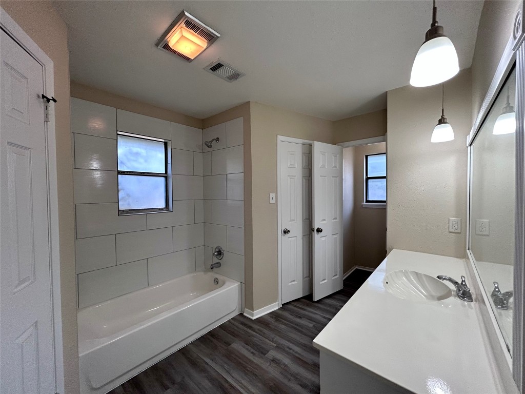 906 Spring Tree Street Round Rock, TX 78681 - Photo 14 of 18 a bathroom with a tub sink and mirror