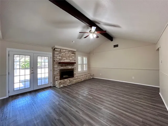 wooden floor in an empty room with a fireplace