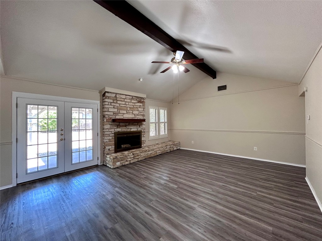 906 Spring Tree Street Round Rock, TX 78681 - Photo 2 of 18 wooden floor in an empty room with a fireplace