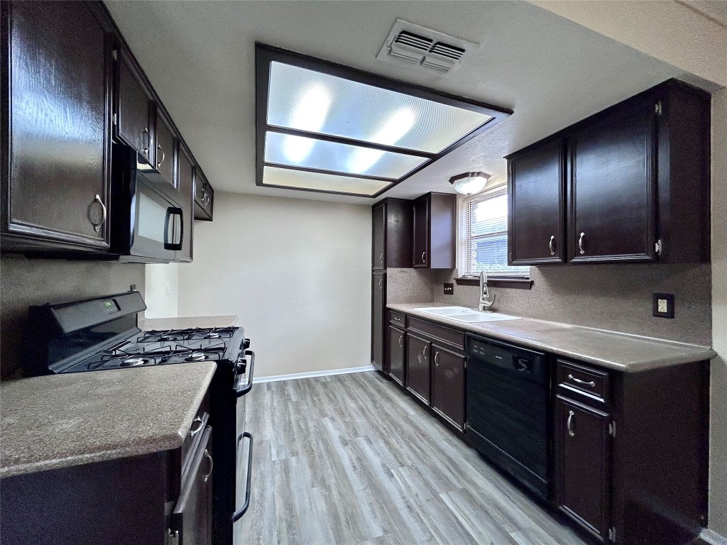 906 Spring Tree Street Round Rock, TX 78681 - Photo 8 of 18 a kitchen with kitchen island granite countertop stainless steel appliances a sink stove top oven and cabinets